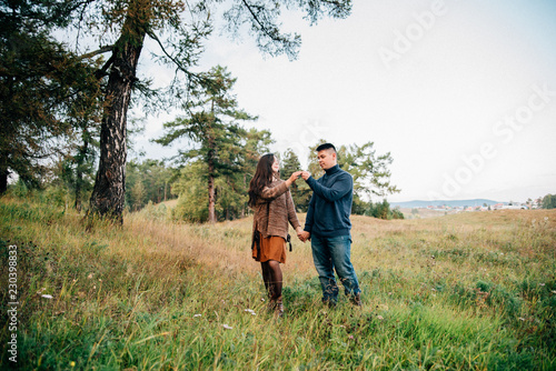 photo shoot of a beautiful brunette and her boyfriend in nature © Евгений Округин