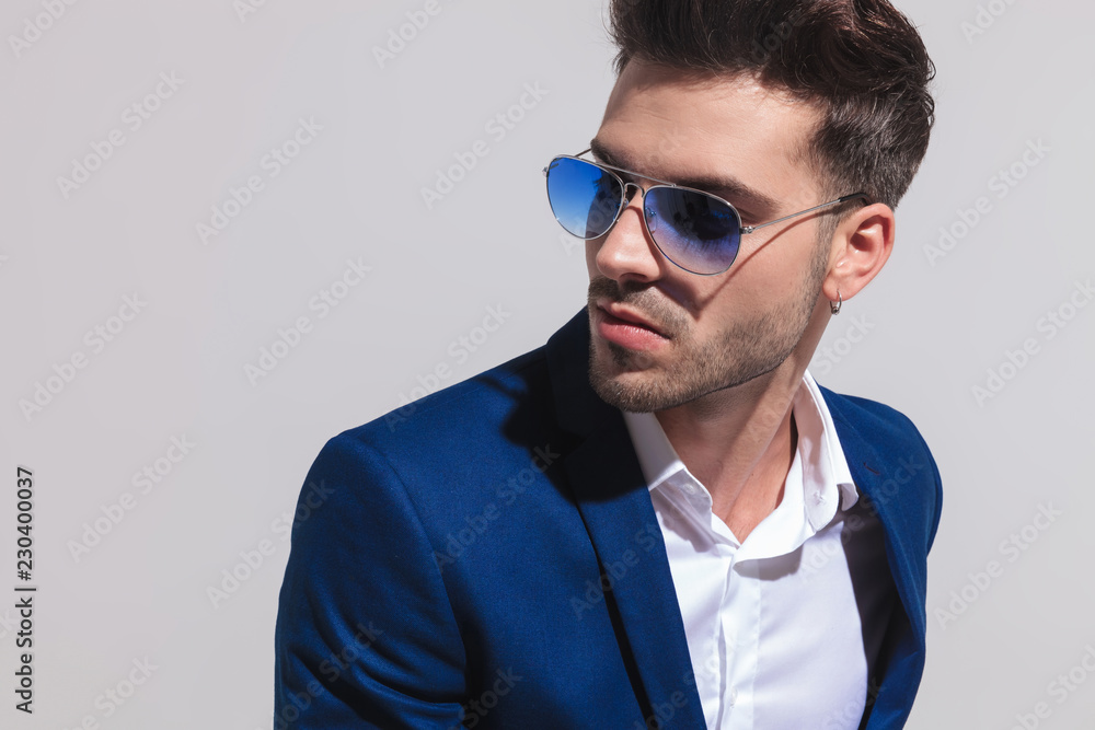 elegant man in sunglasses looking away to side elegant man in sunglasses looking away to side