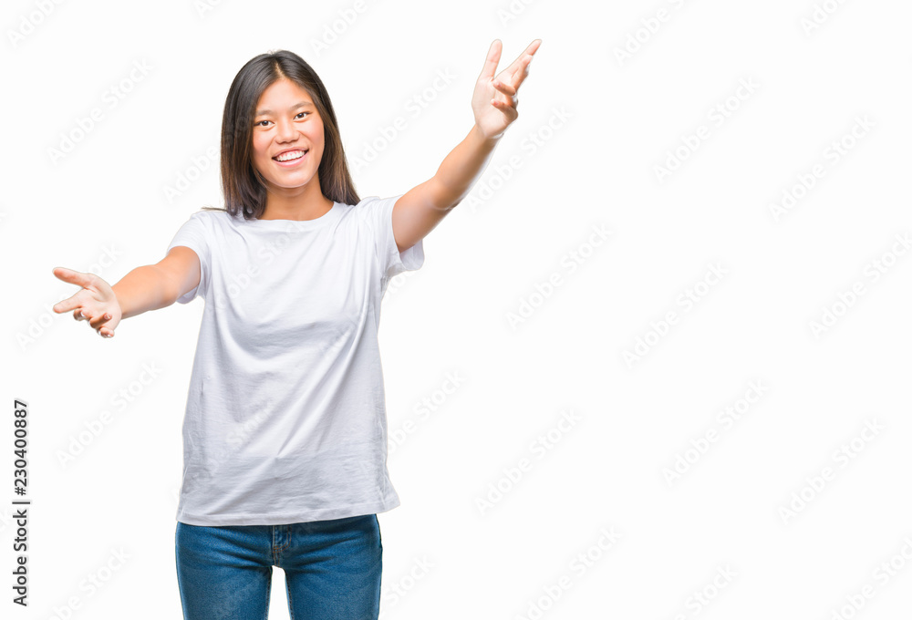 Young asian woman over isolated background looking at the camera smiling with open arms for hug. Cheerful expression embracing happiness. Young asian woman over isolated background looking at the camera smiling with open arms for hug. Cheerful expression embracing happiness.