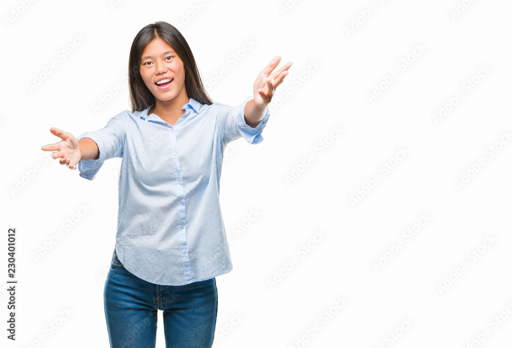 Young asian business woman over isolated background looking at the camera smiling with open arms for hug. Cheerful expression embracing happiness. Young asian business woman over isolated background looking at the camera smiling with open arms for hug. Cheerful expression embracing happiness.