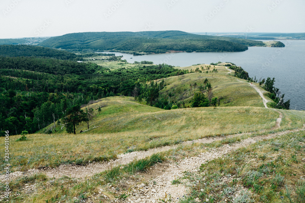 landscape river cliff grass on the sky background