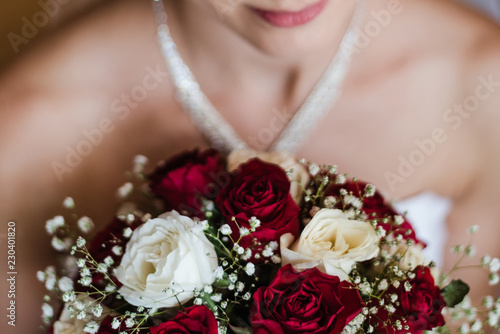 bride holding bouquet, bridal bouquet of roses