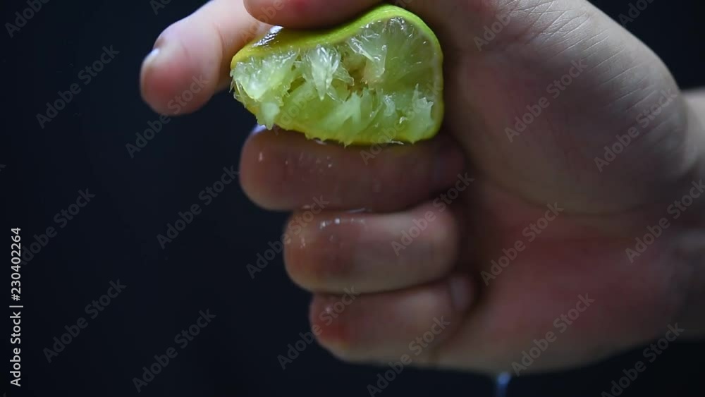 Hands are squeezed lemon black backdrop. Hands are squeezed lemon black backdrop.