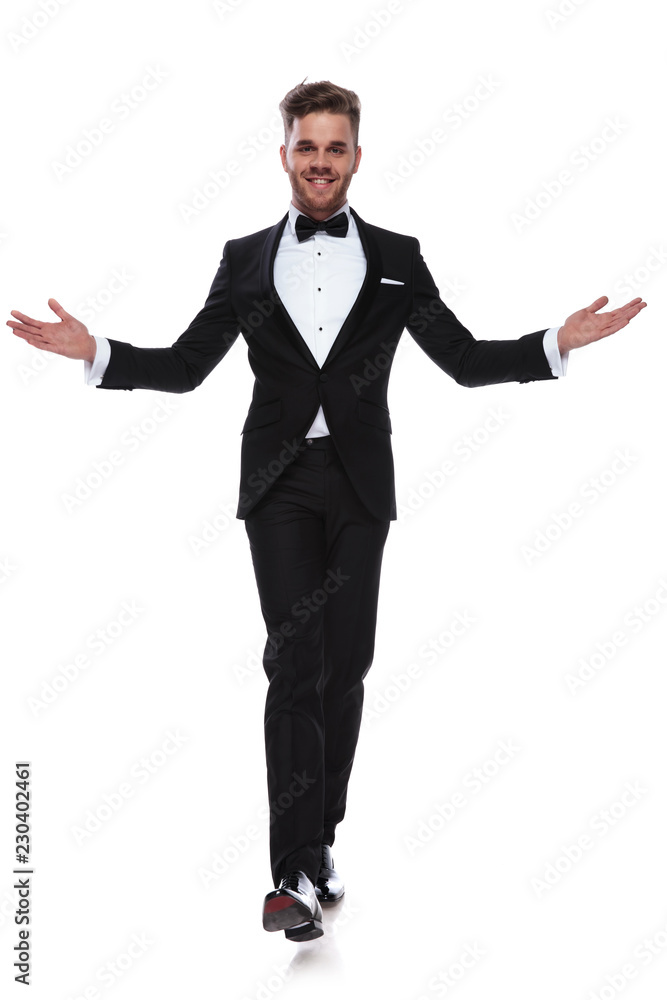smiling young elegant man walking and welcoming smiling young elegant man walking and welcoming