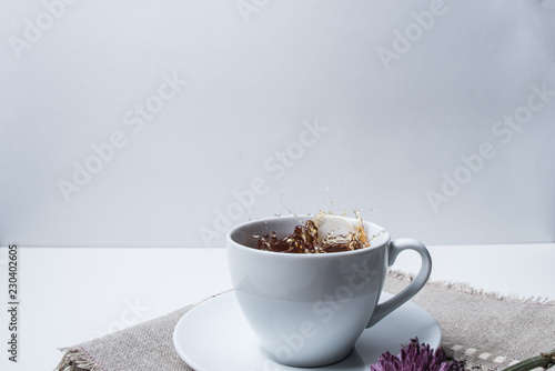 Tea splashing out of a cup isolated on white background.