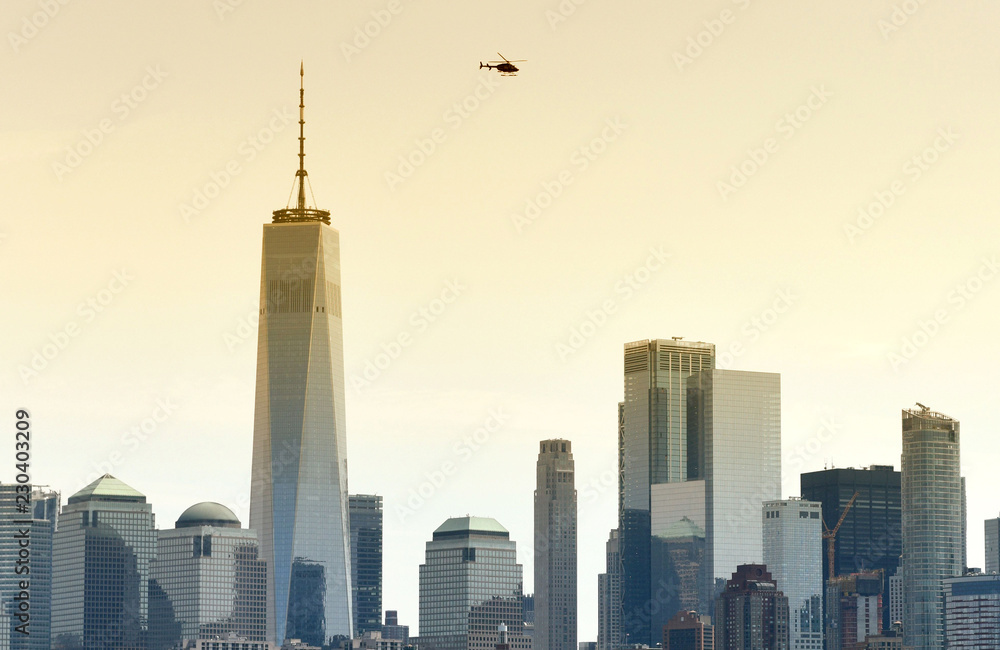 Helicopter fly over the skyscrapers of financial district in lower Manhattan, New York, USA