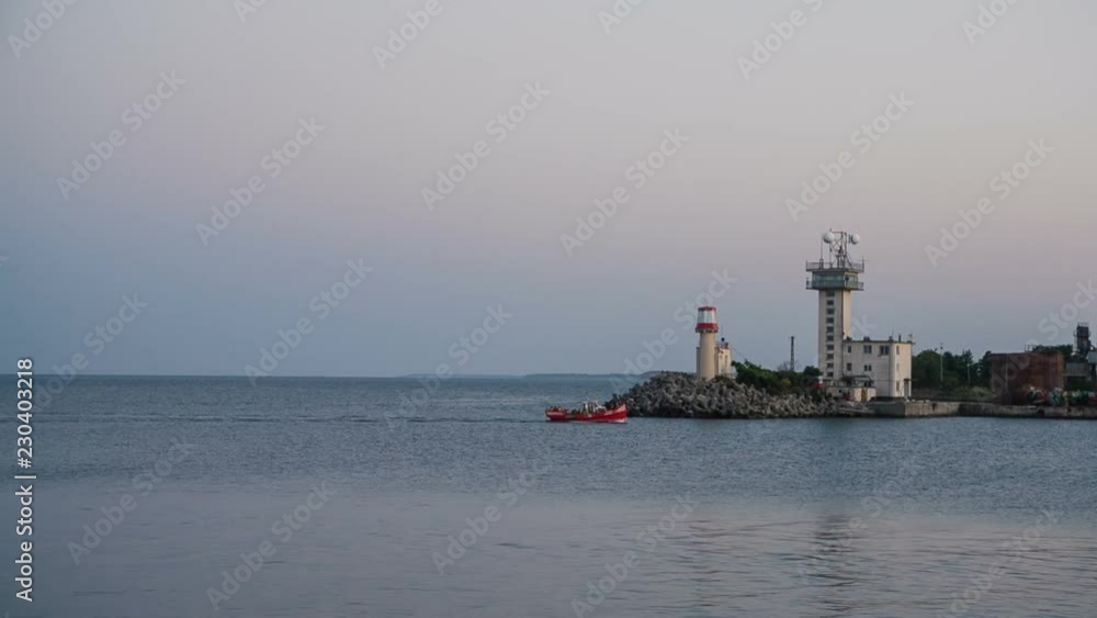 Small red tourist boat entering port Small red tourist boat entering port