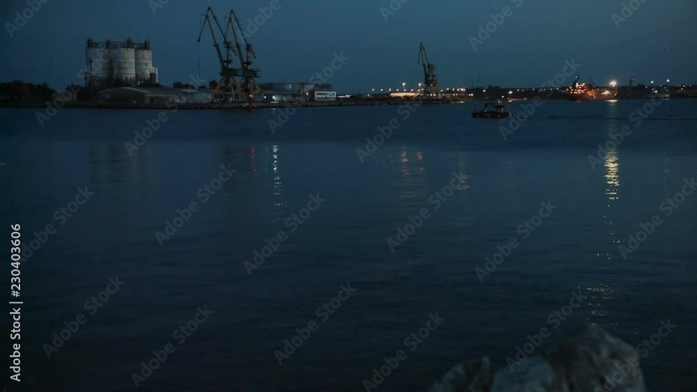 Small boat entering port at the Black Sea at night Small boat entering port at the Black Sea at night