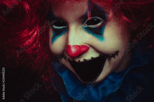 Creepy clown close up halloween portrait on black background