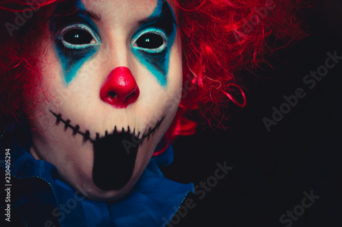Creepy clown close up halloween portrait on black background
