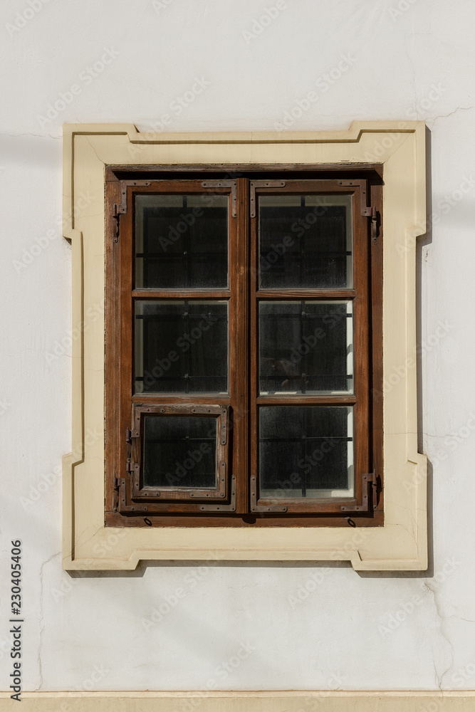 One brown window on the white wall One brown window on the white wall