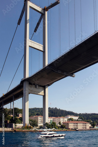 View of luxury yacht, Bosphorus bridge in a sunny summer day in Istanbul.