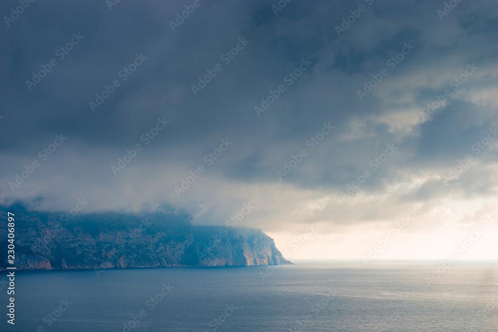 Fototapeta premium Clouds, sea and rocky shore beautiful scenic landscape with dramatic sky