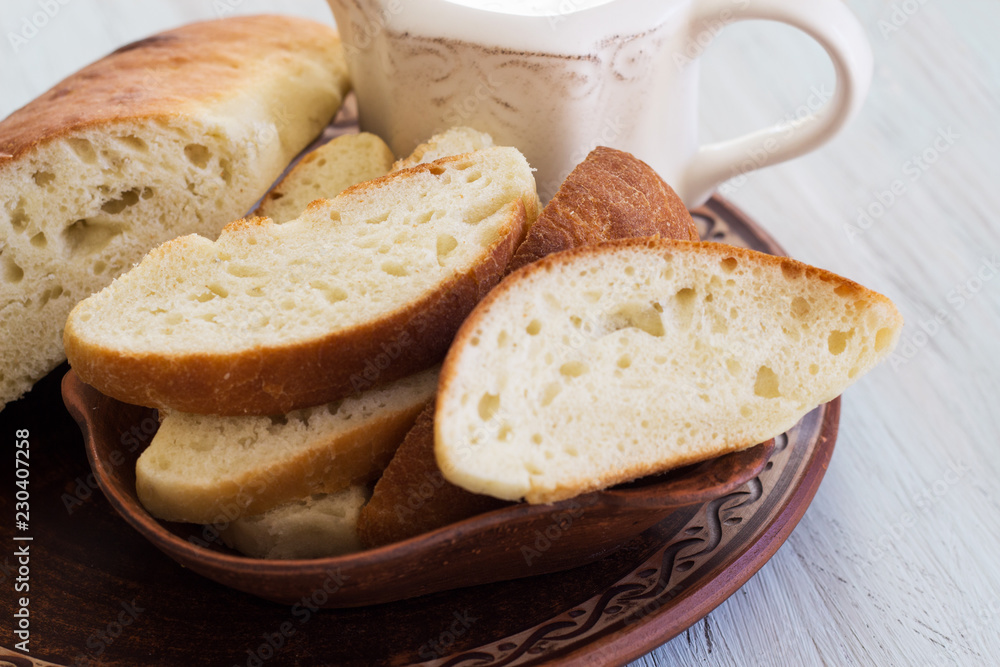 Homemade bread on a ceramic dish. Bread for traditional breakfast. Close-up. Homemade bread on a ceramic dish. Bread for traditional breakfast. Close-up.