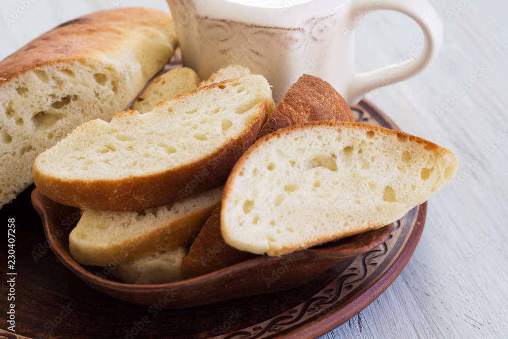 Homemade bread on a ceramic dish. Bread for traditional breakfast. Close-up.