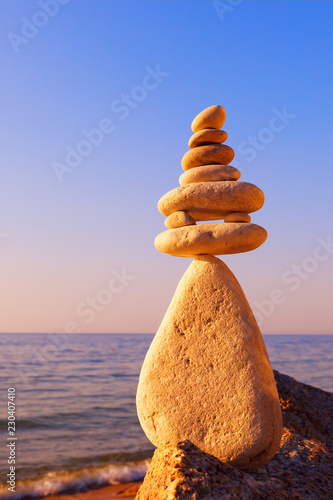 Stones balance on a background of sea sunset. Concept of harmony and balance