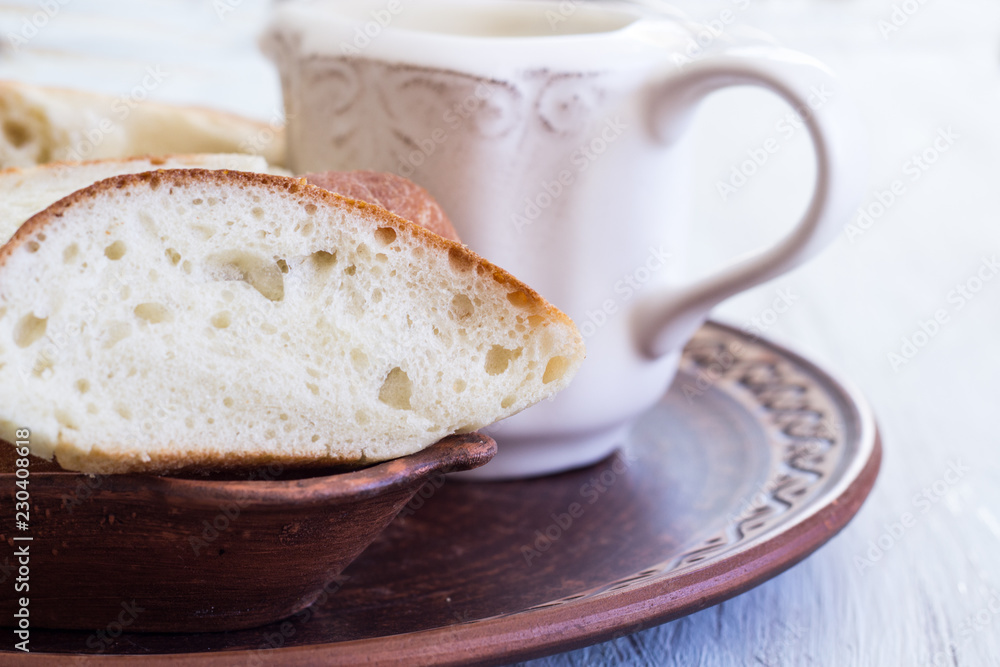 Homemade bread on a ceramic dish. Bread for traditional breakfast. Close-up. Homemade bread on a ceramic dish. Bread for traditional breakfast. Close-up.