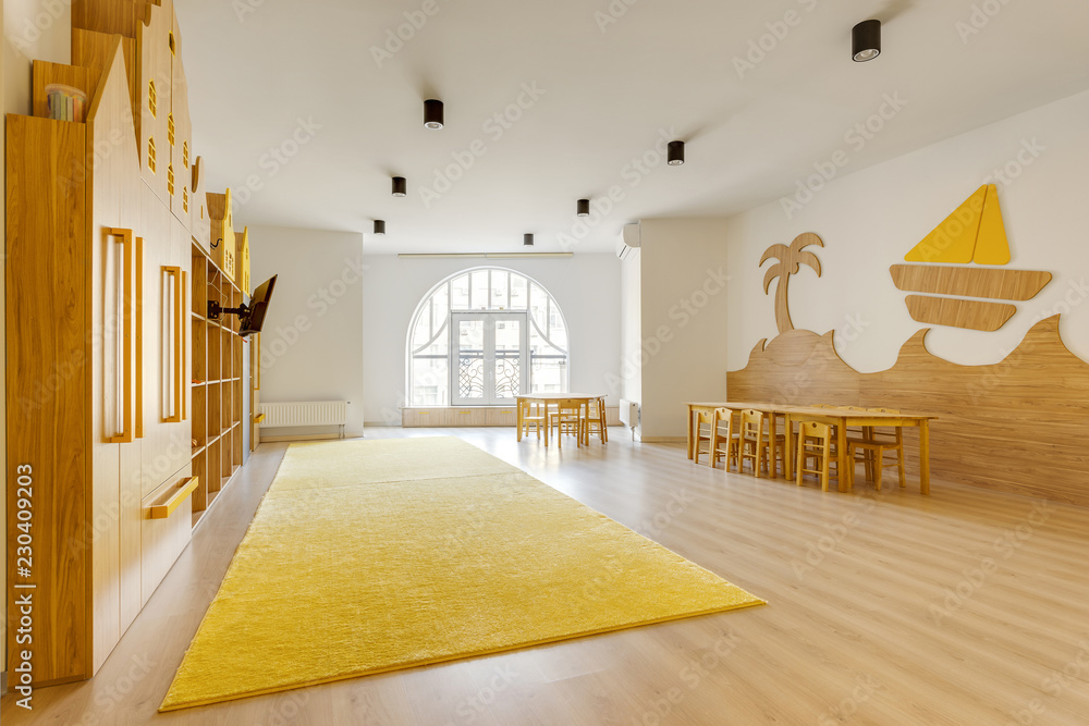 cozy light classroom with wooden furniture in modern kindergarten - obrazy, fototapety, plakaty 