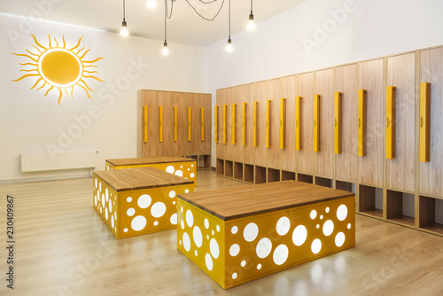 Obraz na plátně wooden lockers in modern illuminated kindergarten cloakroom