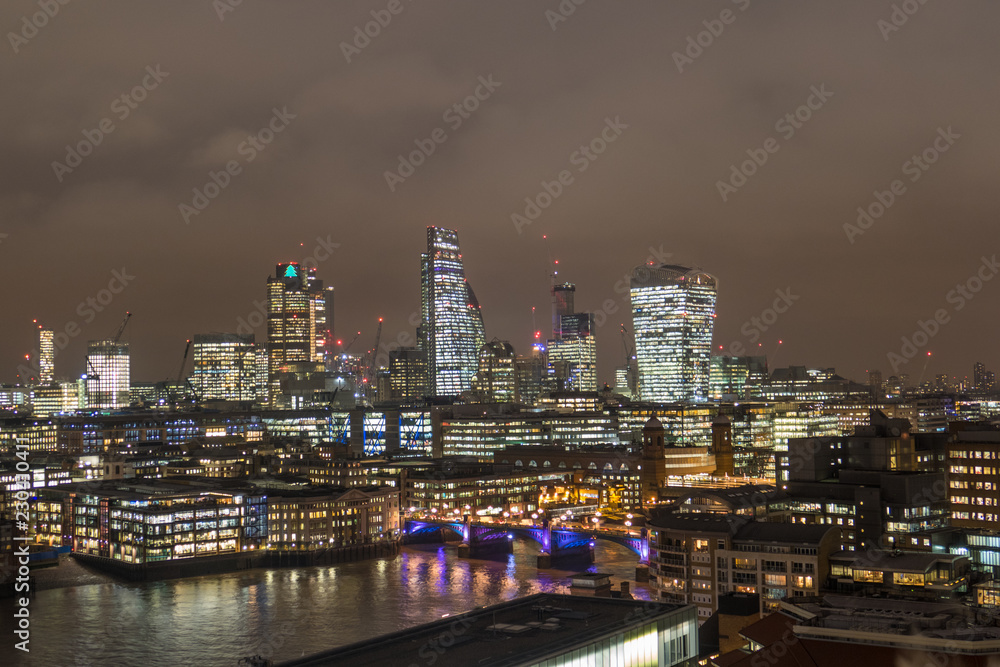 Colorful Business Center Cityscape With View Of River Thames In London, UK At Night.