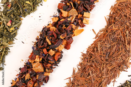 Close up of different mix of tea and dried fruits on white background