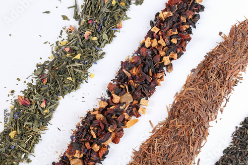 Close up of different mix of tea and dried fruits on white background