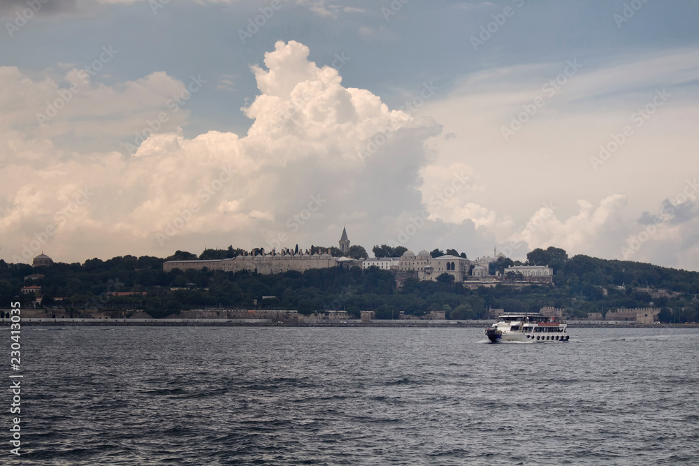 View of a motorboat on Bosphorus. Topkapi palace is in the background in Istanbul.