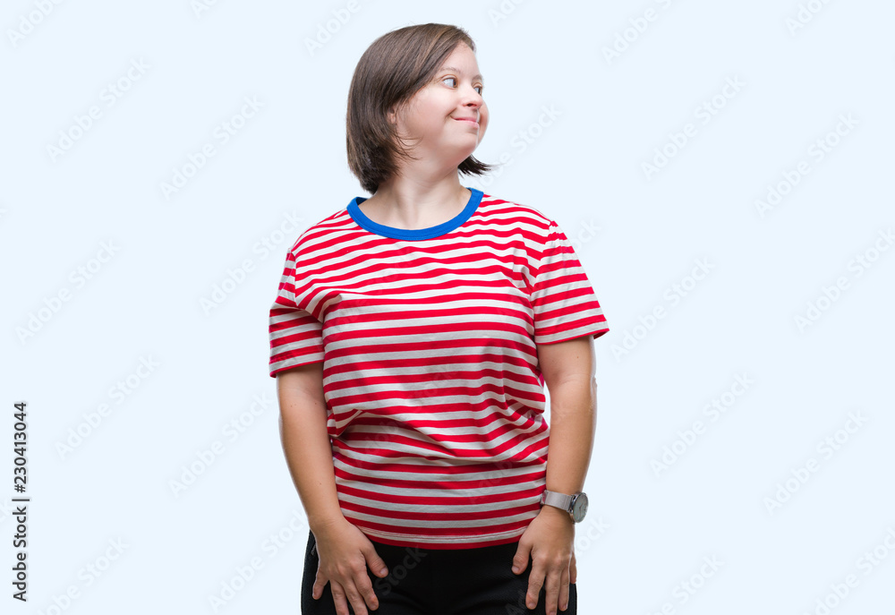 Young adult woman with down syndrome over isolated background looking away to side with smile on face, natural expression. Laughing confident. Young adult woman with down syndrome over isolated background looking away to side with smile on face, natural expression. Laughing confident.