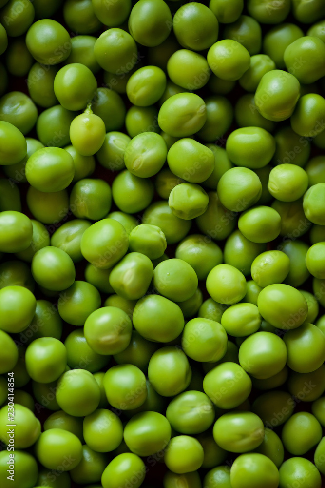 Beans and pods of green peas lie on a large number of other peas. Beans and pods of green peas lie on a large number of other peas.