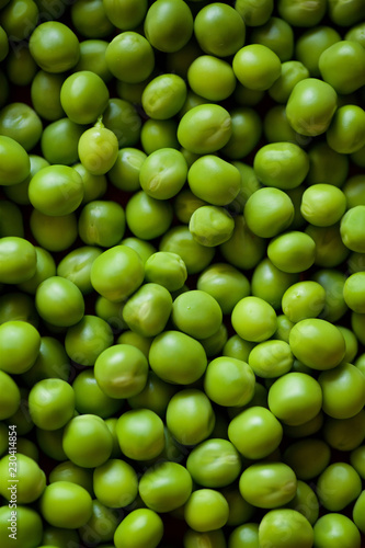 Beans and pods of green peas lie on a large number of other peas. © Fotoproff