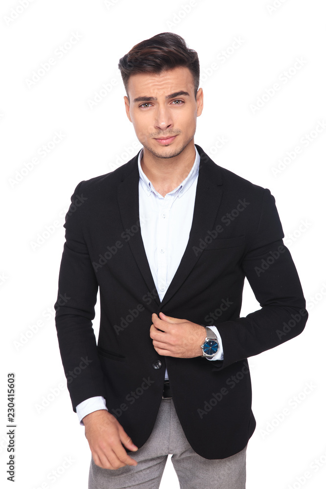 portrait of handsome businessman buttoning his black suit portrait of handsome businessman buttoning his black suit