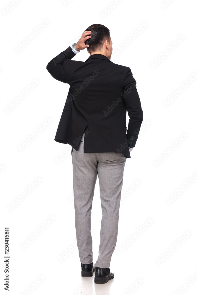 back view of pensive businessman holding head while standing back view of pensive businessman holding head while standing