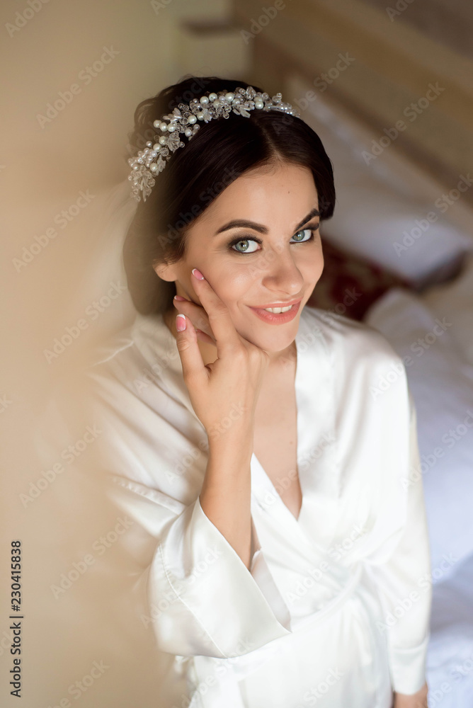 Portrait of beautiful bride with fashion veil posing on bed at wedding morning. Makeup. Brunette girl. Wedding veil. Portrait of beautiful bride with fashion veil posing on bed at wedding morning. Makeup. Brunette girl. Wedding veil.