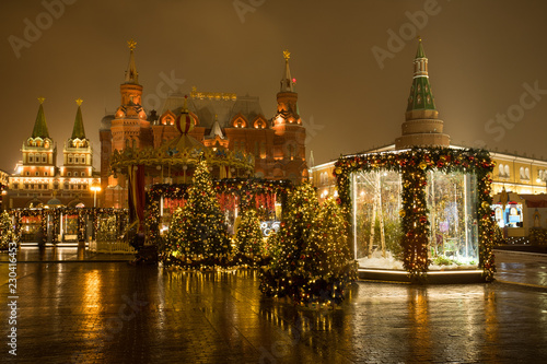 Moscow  Russia. Beautiful Decorated Christmas Trees At Manege Square  On Background Lverskaya Chapel  State Historical Museum And Moscow Kremlin In Evening At Winter.