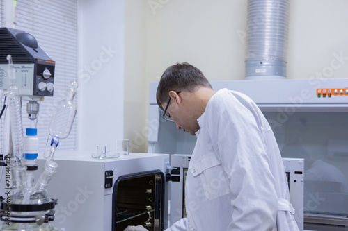 Serious clinician studying chemical element in working environment