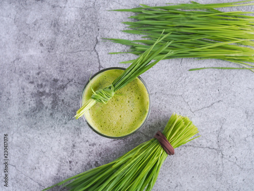 Fresh wheat grass juice and wheatgrass plant for health on top view. Nutrition food.