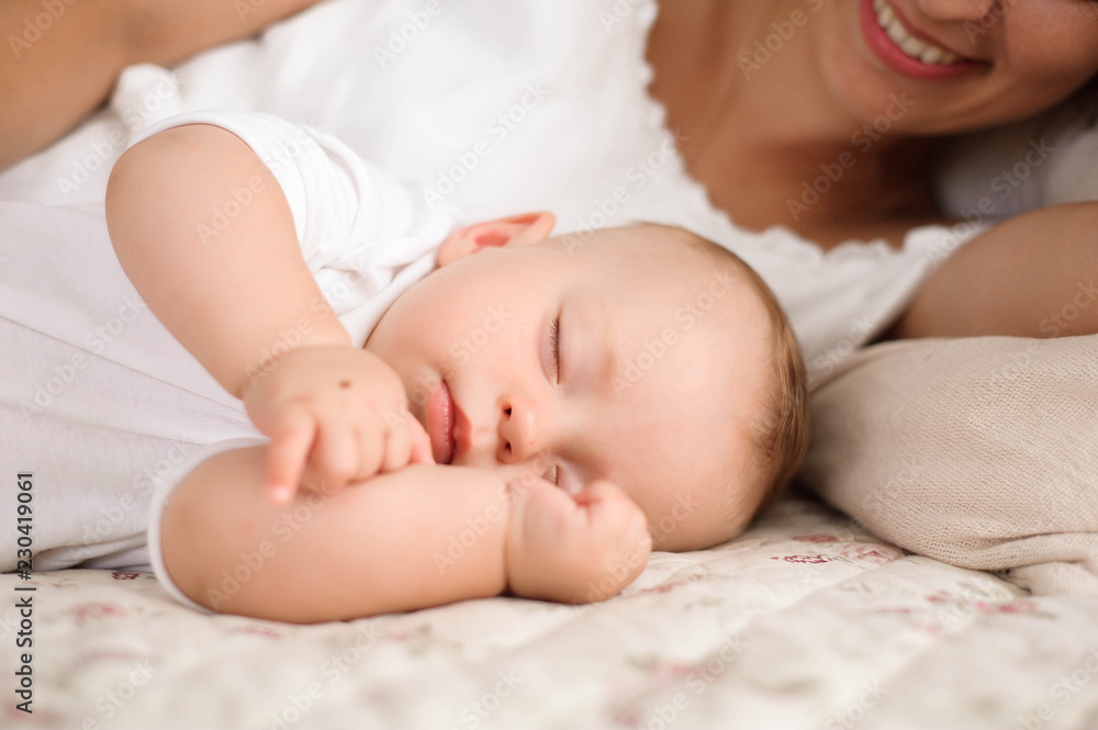 Sweet baby boy sleeping in bed with his mother Sweet baby boy sleeping in bed with his mother