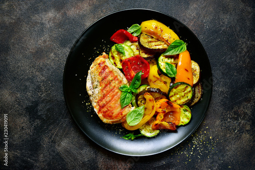 Grilled chiken fillet with vegetables.Top view.