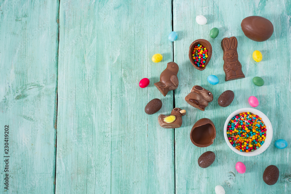 Easter composition with chocolate eggs and animals on wooden surface Easter composition with chocolate eggs and animals on wooden surface