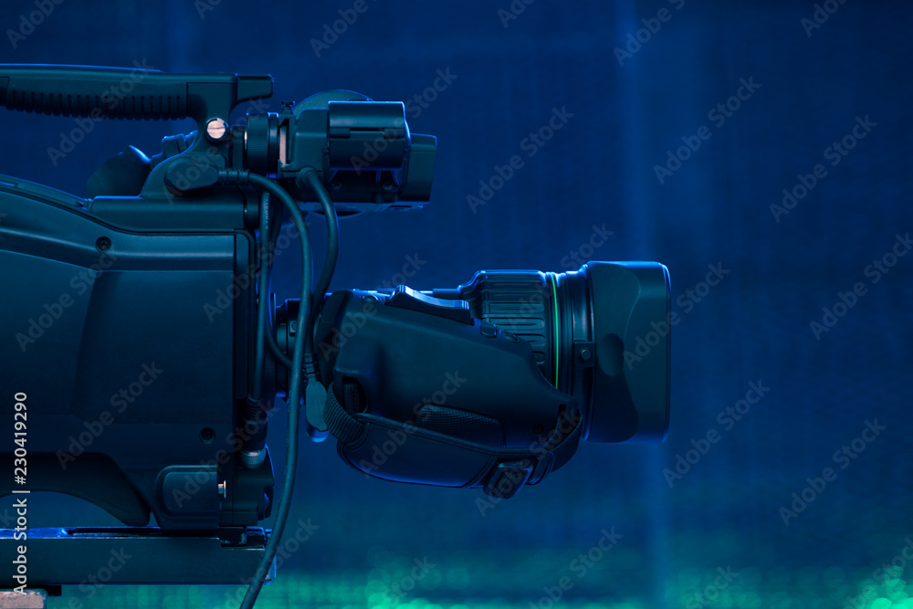 Video camera lens recording show in TV studio focus on camera