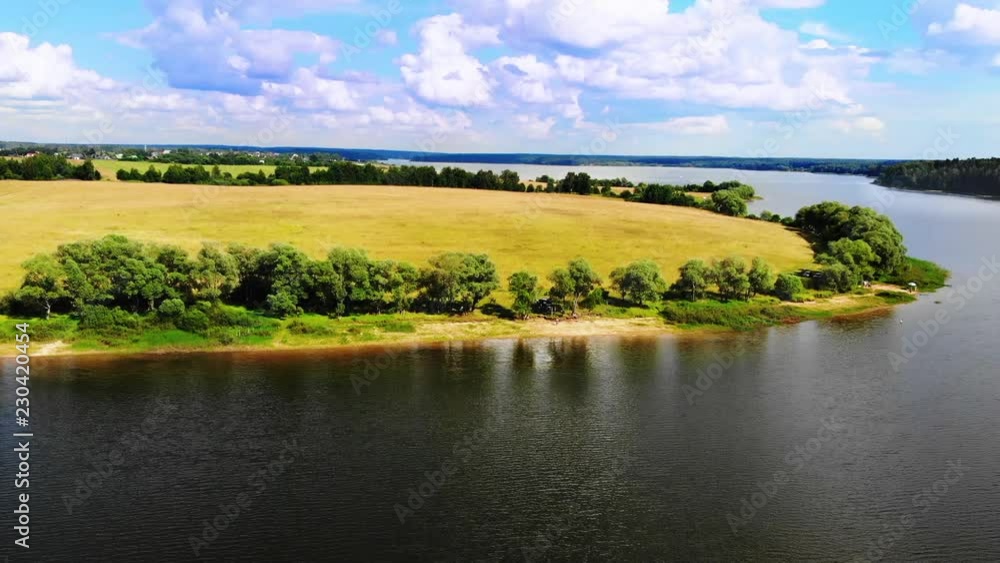 Ruza, Russia - August, 2018: Wonderful lake on a peninsula against the blue sky with beautiful clouds. Ruza, Russia - August, 2018: Wonderful lake on a peninsula against the blue sky with beautiful clouds.