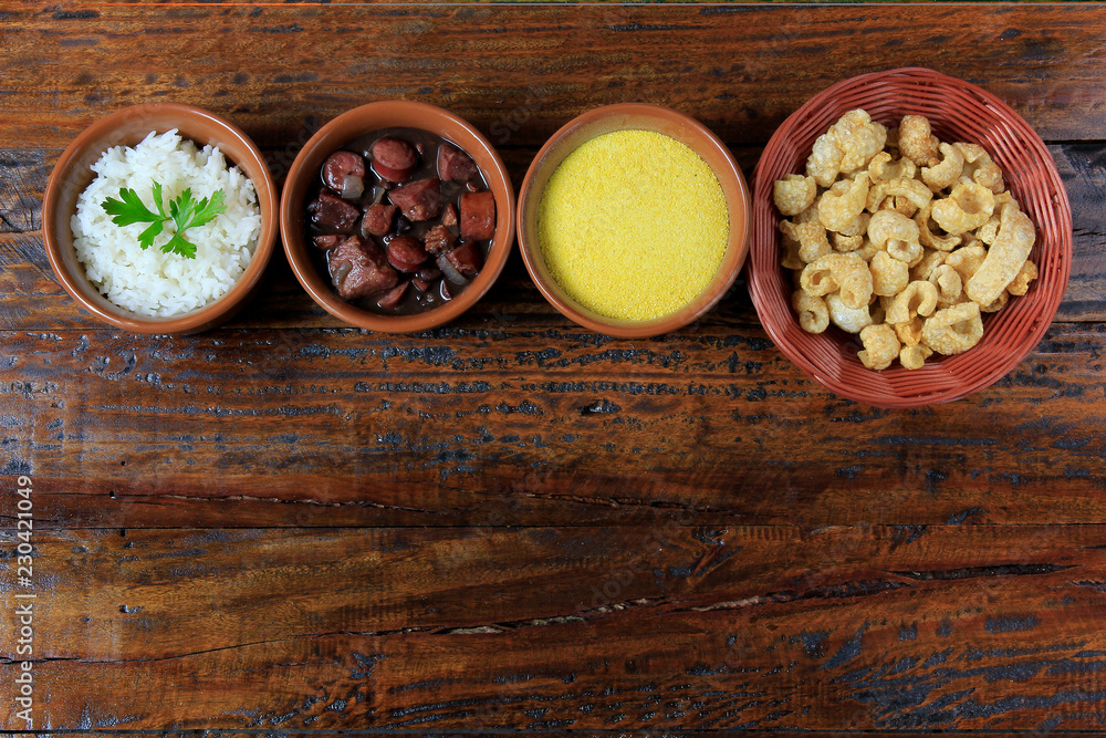 Brazilian feijoada, traditional dish of the Brazilian cuisine, on wooden table Brazilian feijoada, traditional dish of the Brazilian cuisine, on wooden table