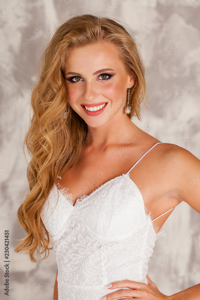 Smart blond lady wearing white dress Smart blond lady wearing white dress
