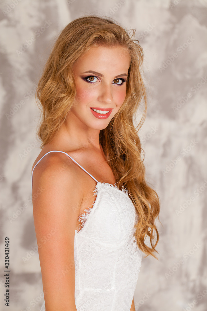Smart blond lady wearing white dress Smart blond lady wearing white dress