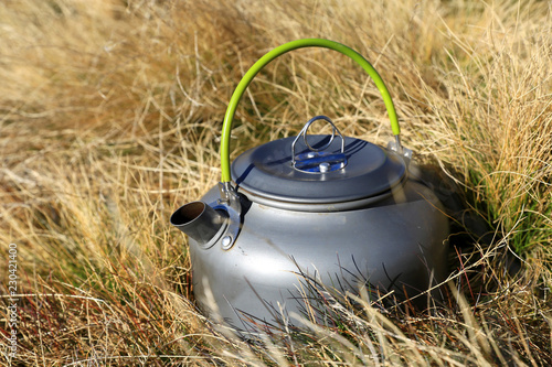 Tourist kettle in grass