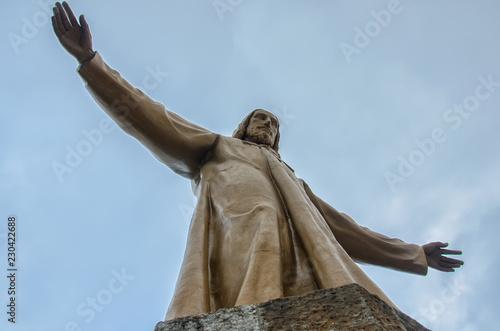 Statue of Christ on the top of temple of the Blazing Heart on the hill of Tibidabo in Barcelona, Spain. photo