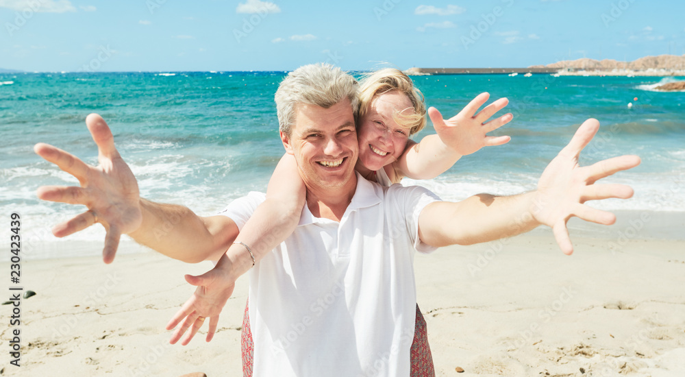 vacation at sea. cheerful man and woman at seashore vacation at sea. cheerful man and woman at seashore