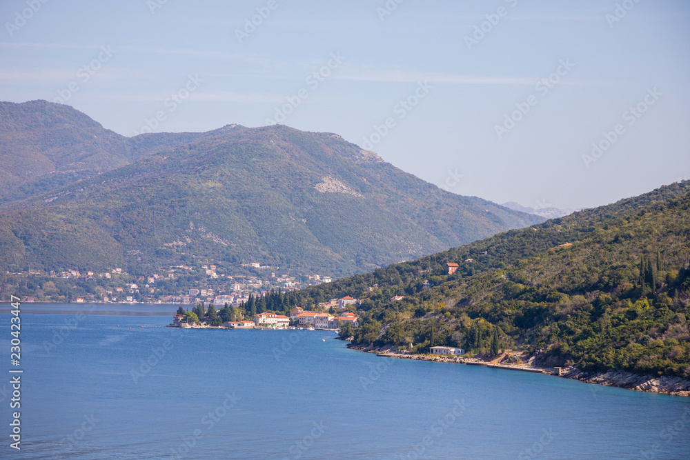 Scenic view of old town, mountains and the coast from water of Kotor bay in Montenegro