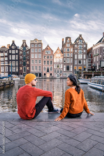 Photography Amsterdam Damrak during sunset, happy couple man and woman on a summer evening a