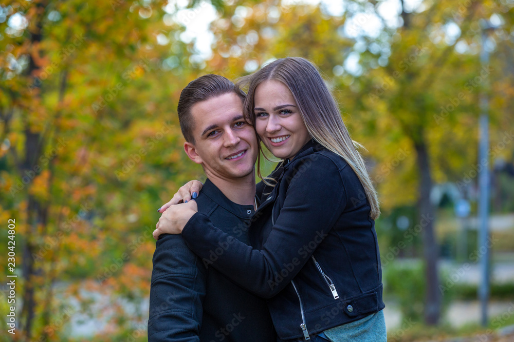 Young couple in love walking in the autumn park Young couple in love walking in the autumn park